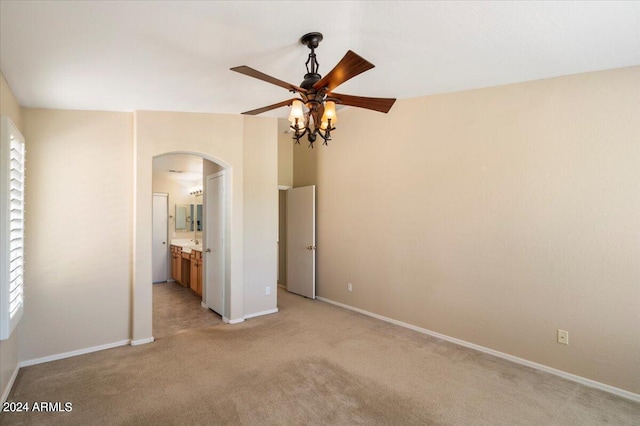 interior space with light colored carpet and ceiling fan