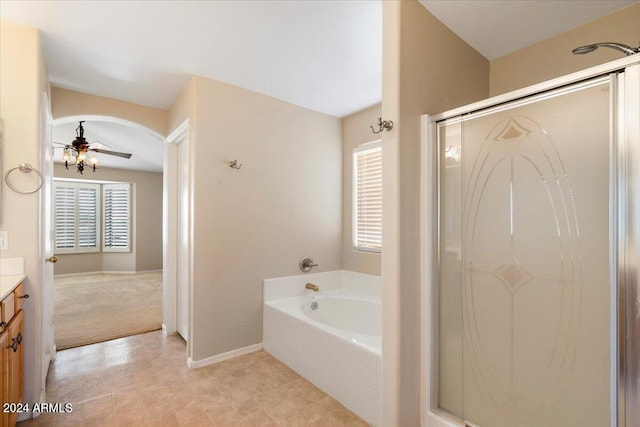 bathroom with vanity, plus walk in shower, and ceiling fan