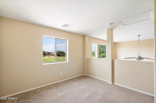 carpeted spare room with ceiling fan and a wealth of natural light