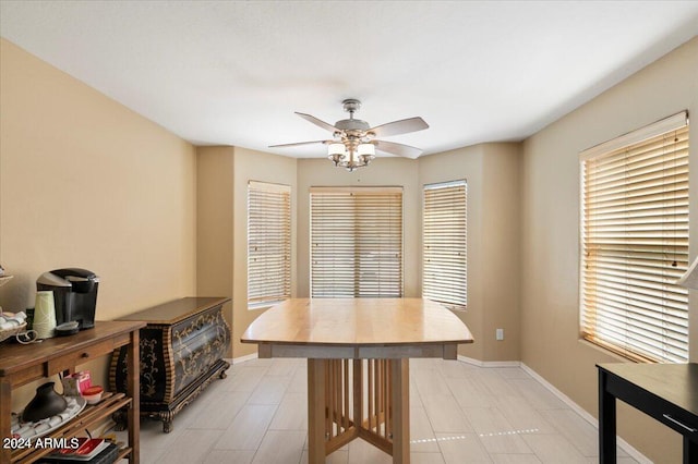 tiled dining area featuring ceiling fan