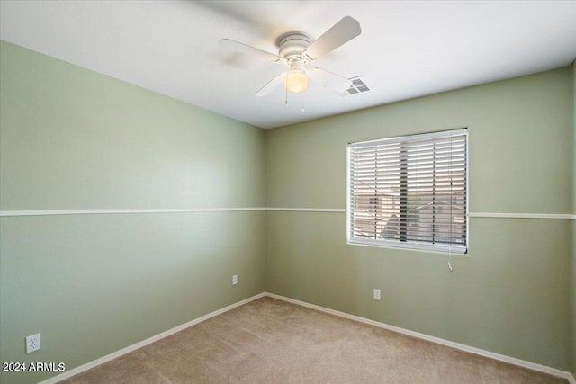 unfurnished room featuring light carpet and ceiling fan