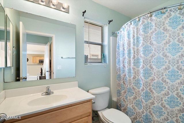 bathroom with toilet, a shower with curtain, and vanity