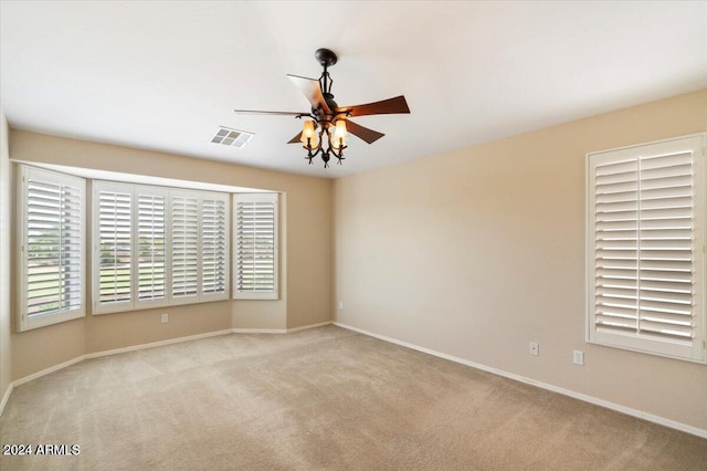 carpeted empty room featuring ceiling fan