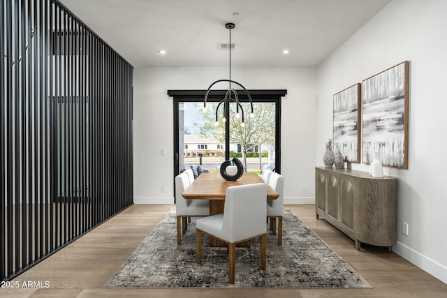 dining space with baseboards, light wood-style flooring, and recessed lighting