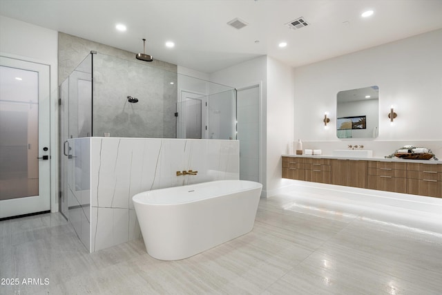 bathroom featuring vanity, a shower stall, visible vents, and recessed lighting