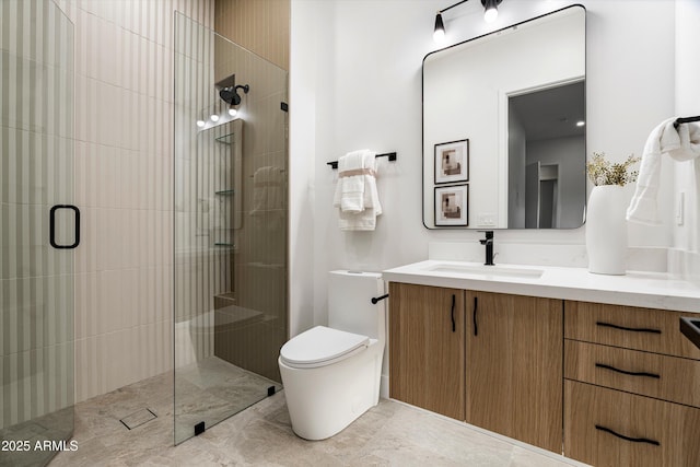 full bath featuring a tile shower, vanity, and toilet