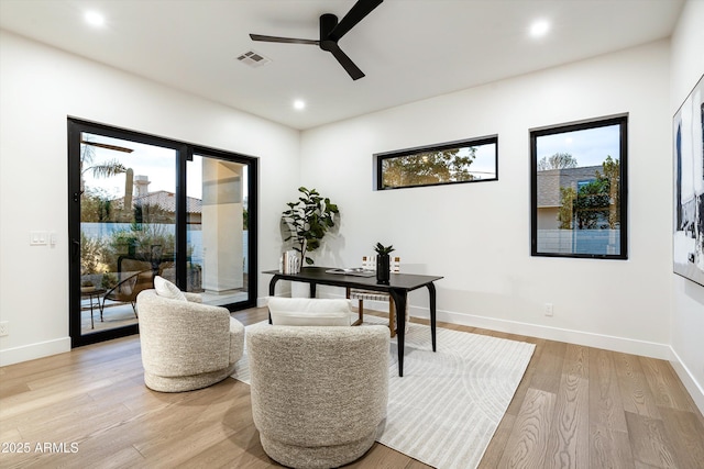 office area with a healthy amount of sunlight, light wood finished floors, baseboards, and visible vents