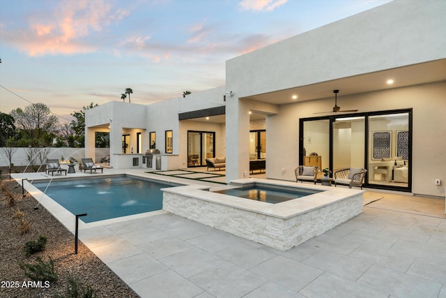 pool at dusk featuring a ceiling fan, a patio, an outdoor living space, and area for grilling