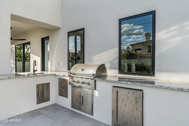 view of patio / terrace with a sink, an outdoor kitchen, and area for grilling