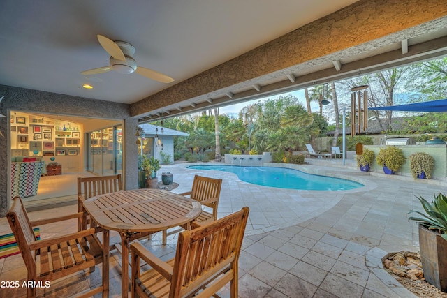 view of swimming pool featuring ceiling fan and a patio area