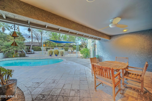 view of swimming pool with ceiling fan and a patio area