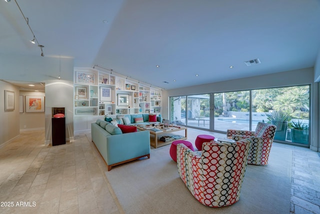 living room featuring vaulted ceiling and rail lighting