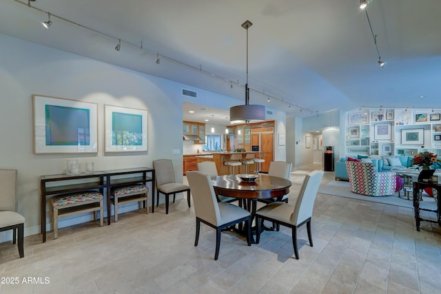 dining space featuring track lighting