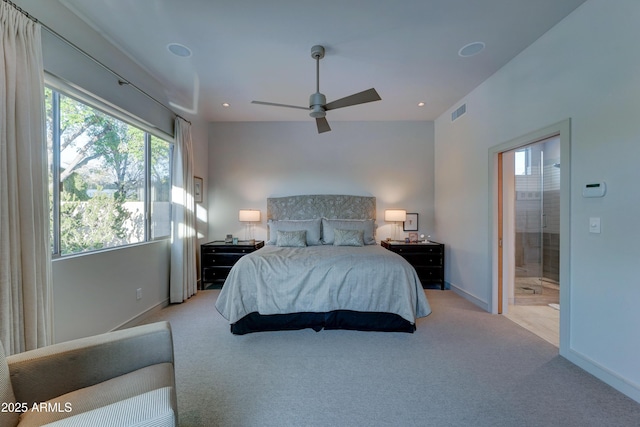 bedroom featuring light carpet, ensuite bath, and ceiling fan