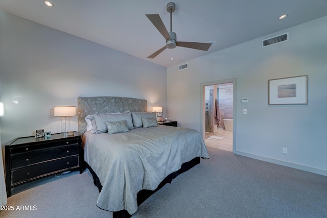 carpeted bedroom with ceiling fan and ensuite bath