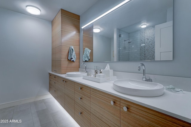 bathroom with vanity, tile patterned flooring, and a shower