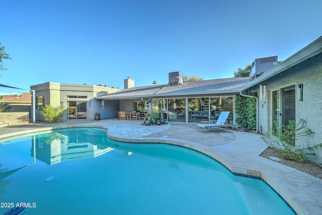 view of swimming pool with central AC and a patio