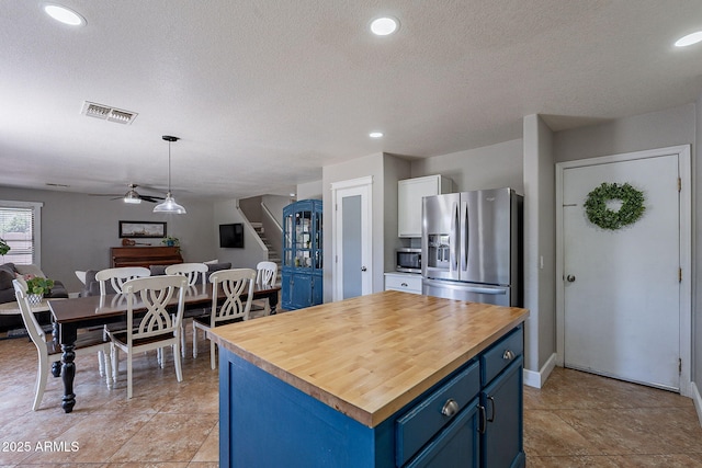3047 S Mandy St, Mesa, AZ 85212 - kitchen with appliances with stainless steel finishes, blue cabinetry, wooden counters, ceiling fan, and open floor plan