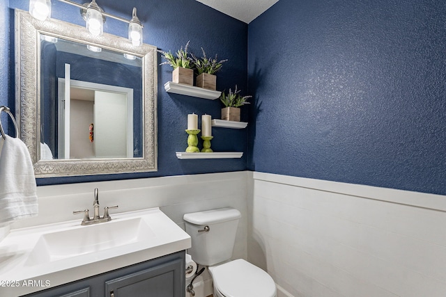3047 S Mandy St, Mesa, AZ 85212 - bathroom with vanity, a textured wall, and a wainscoted wall