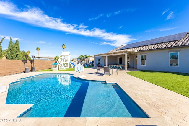 view of pool featuring a playground, a fenced backyard, a fenced in pool, outdoor dining space, and a patio area