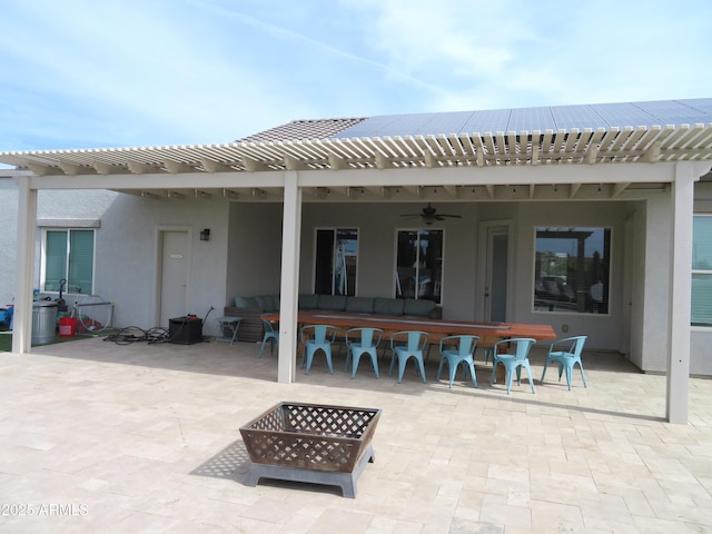 view of patio / terrace with a pergola, ceiling fan, a fire pit, and exterior bar