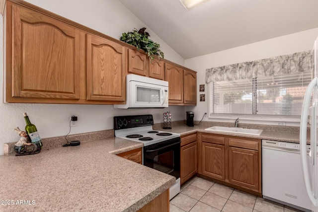 kitchen with white appliances, a sink, vaulted ceiling, light tile patterned floors, and light countertops