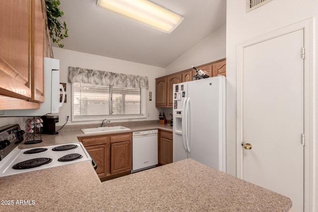 kitchen featuring white appliances, a sink, vaulted ceiling, light countertops, and brown cabinets