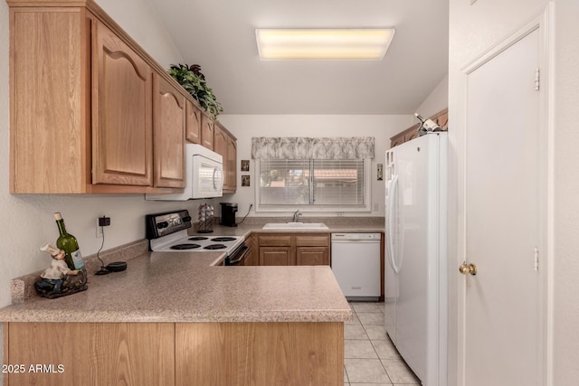 kitchen featuring white appliances, a sink, light countertops, light tile patterned floors, and a peninsula