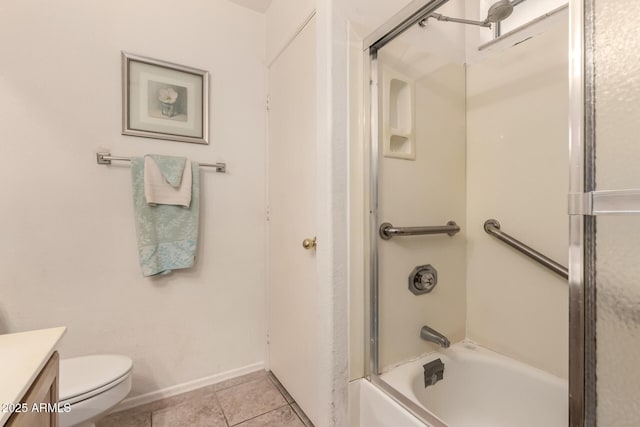 bathroom featuring vanity, combined bath / shower with glass door, tile patterned flooring, toilet, and baseboards