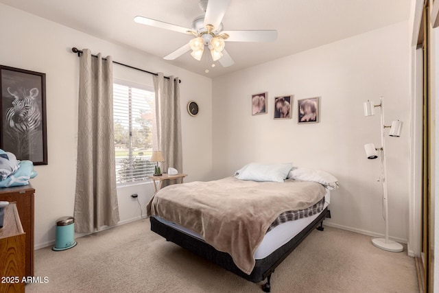 bedroom with carpet, baseboards, and a ceiling fan