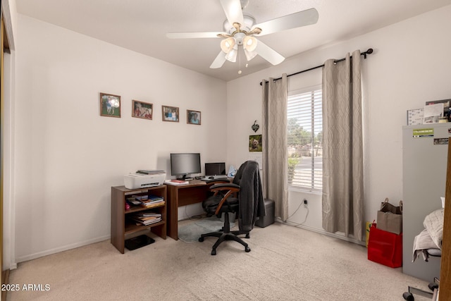 carpeted home office with ceiling fan