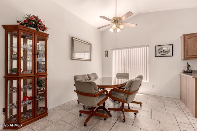 dining room featuring lofted ceiling, ceiling fan, and light tile patterned floors