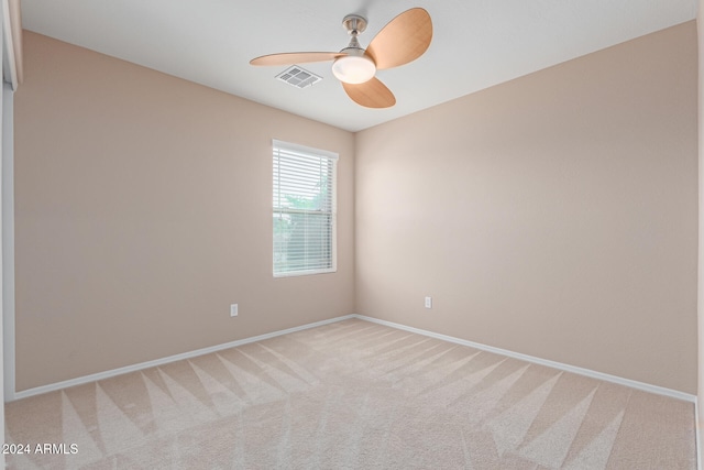 spare room featuring carpet floors and ceiling fan