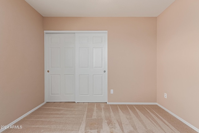 unfurnished bedroom with a closet and carpet