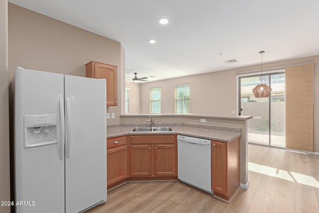 kitchen with white appliances, sink, decorative light fixtures, light hardwood / wood-style floors, and ceiling fan