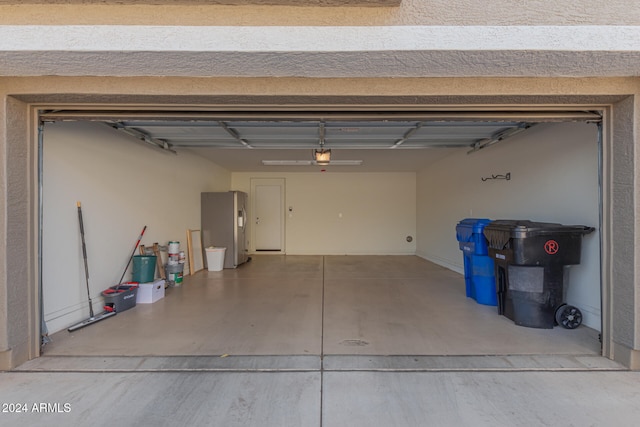 garage with stainless steel fridge