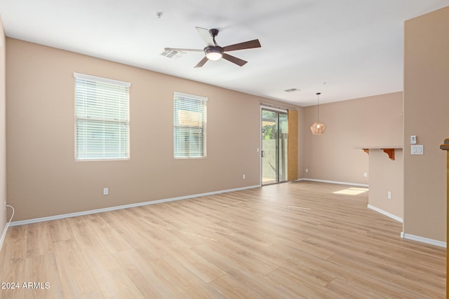 spare room featuring ceiling fan and light hardwood / wood-style flooring