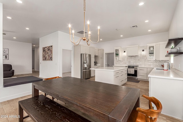 dining space with sink and light hardwood / wood-style flooring