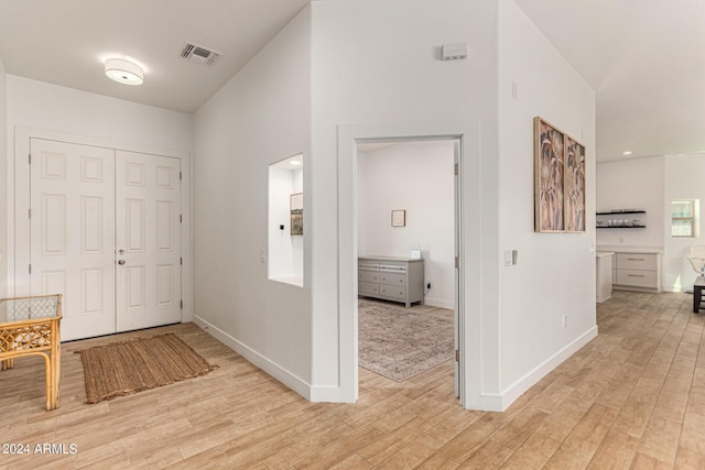 corridor with light hardwood / wood-style floors