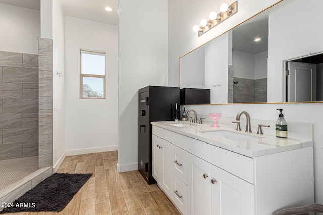 bathroom with vanity and a tile shower