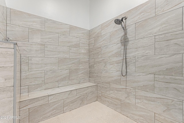 bathroom with tiled shower