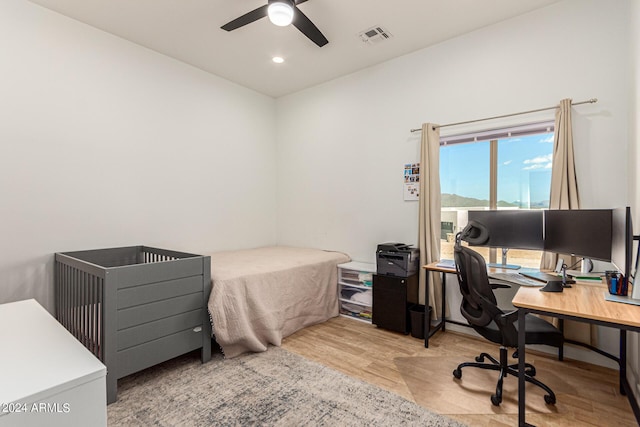 bedroom with ceiling fan and light hardwood / wood-style flooring