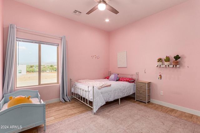 bedroom with ceiling fan and light wood-type flooring