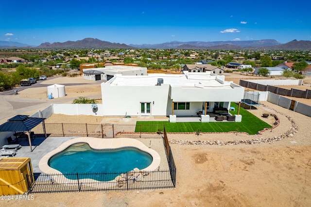 view of swimming pool with a mountain view and a patio