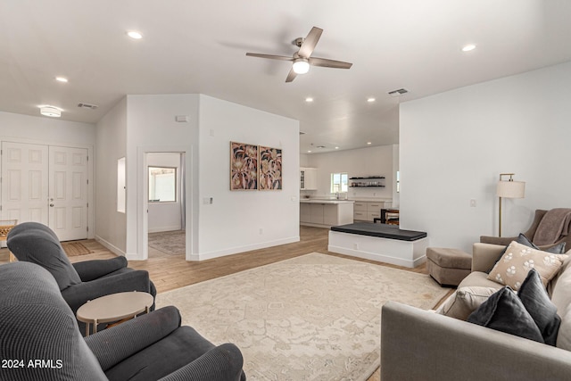 living room featuring ceiling fan and light wood-type flooring