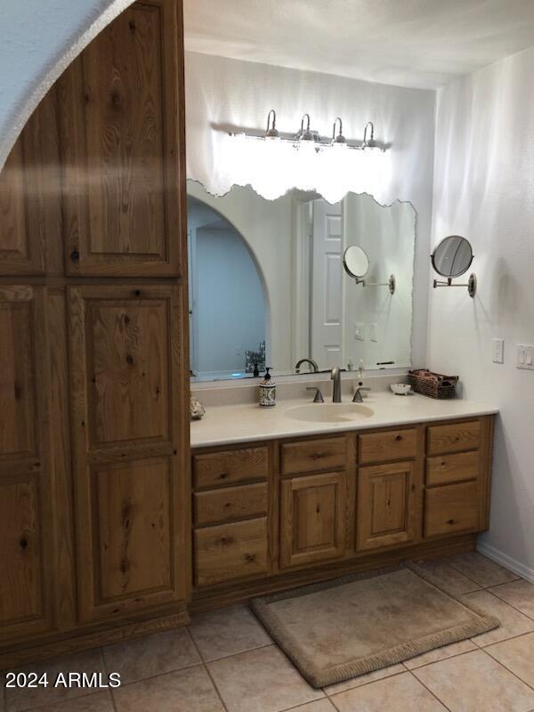 bathroom with tile patterned flooring and vanity