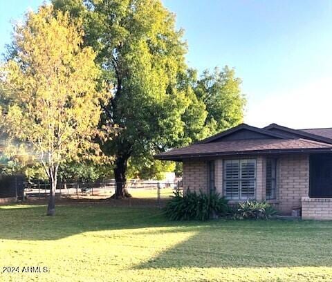 view of home's exterior with a yard