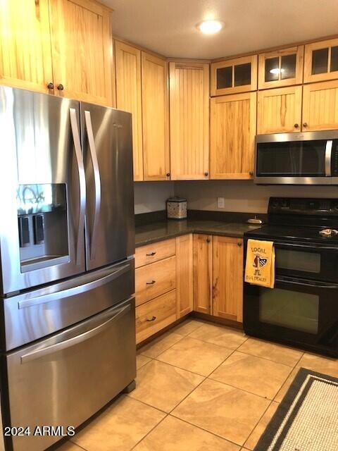 kitchen featuring light tile patterned flooring and appliances with stainless steel finishes