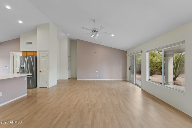 unfurnished living room with recessed lighting, visible vents, ceiling fan, high vaulted ceiling, and light wood-type flooring