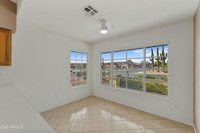 unfurnished dining area featuring light tile patterned floors, ceiling fan, and visible vents